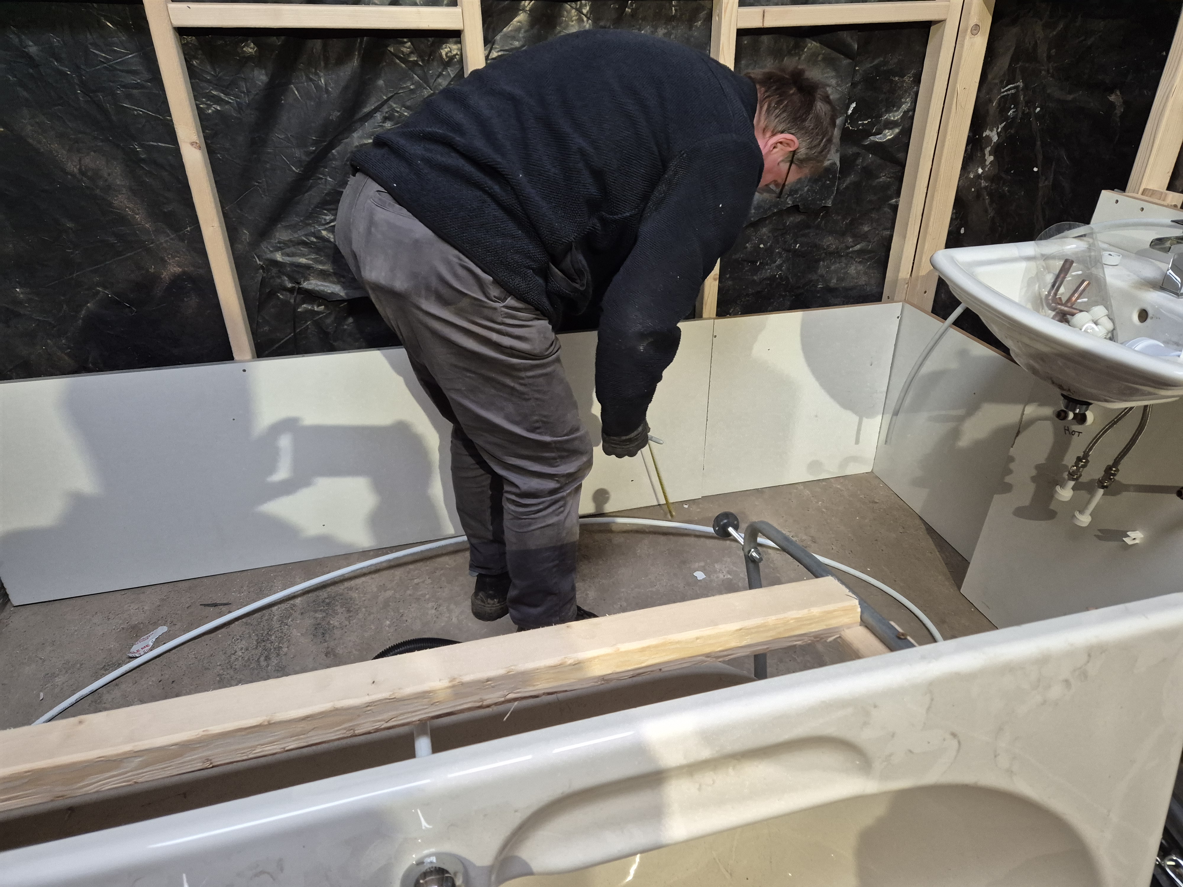Hands-on bathroom fitting practice inside the training workshop